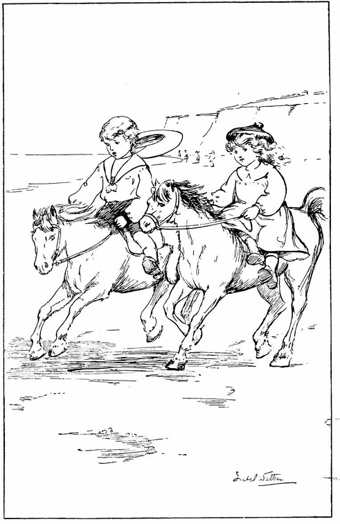 Two children riding ponies on the beach.jpg