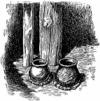 An earthen pot full of water stood by one of the posts near the fire
